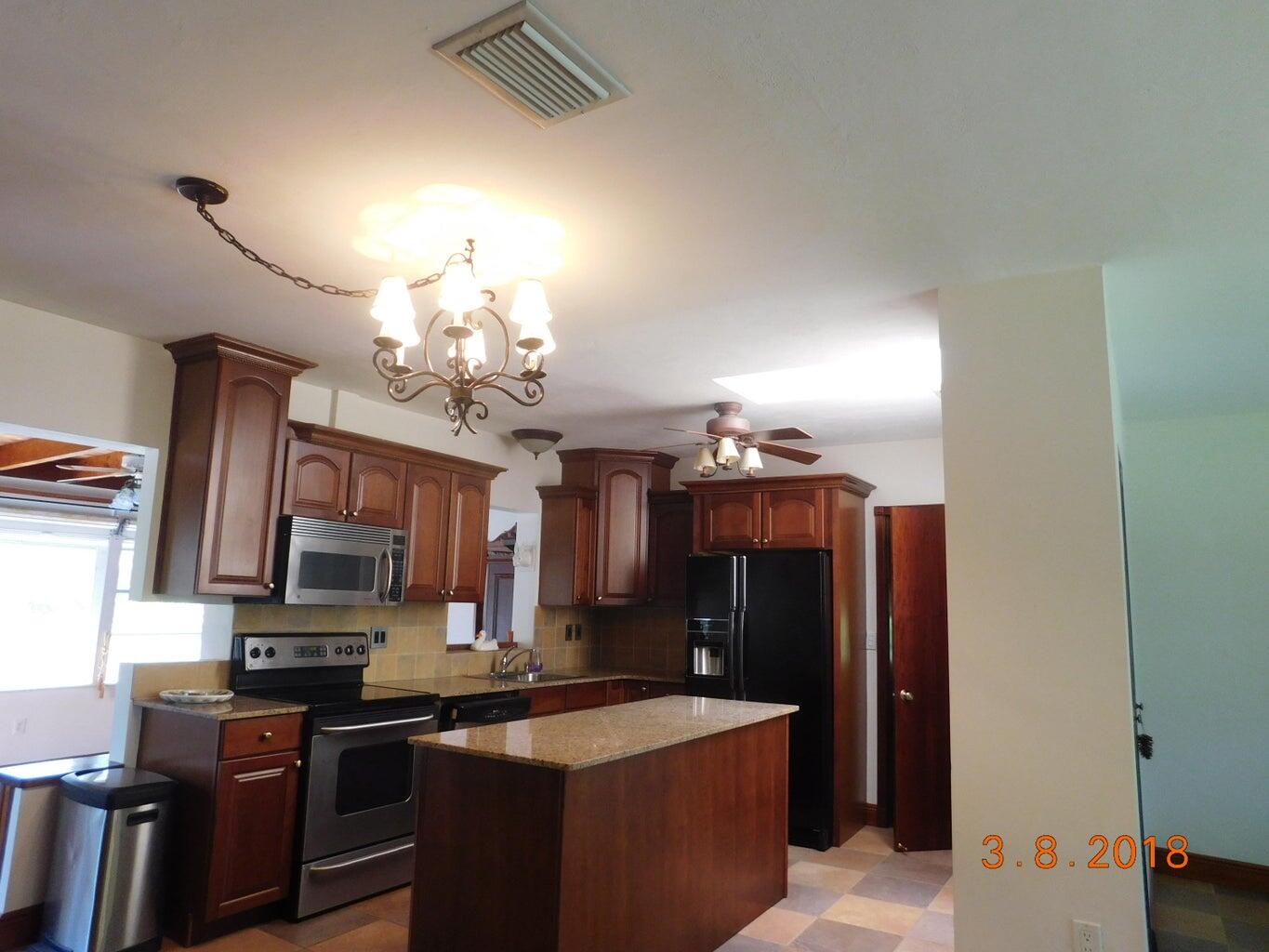 6608 Southwest 65th Street South Miami, FL 33143 - Photo 8 of 25 a kitchen with stainless steel appliances a sink stove and refrigerator