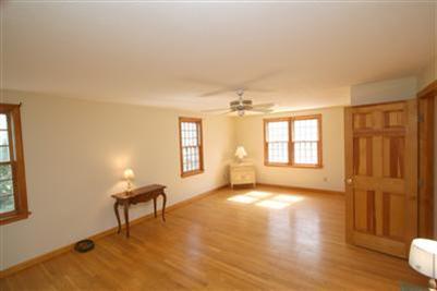 44 Joshua Jethro Road Harwich, MA 02645 - Photo 15 of 21 a view of a livingroom with a piano and wooden floor