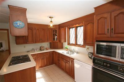 44 Joshua Jethro Road Harwich, MA 02645 - Photo 9 of 21 a kitchen with a sink stove top oven and cabinets