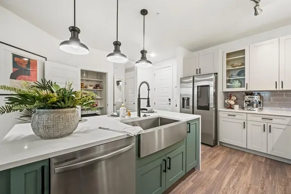 a kitchen with stainless steel appliances kitchen island wooden cabinets and a stove top oven