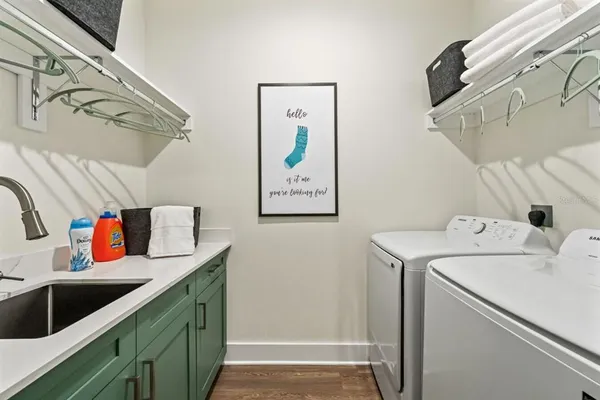 a bedroom with a large bed a flat tv screen and a dresser