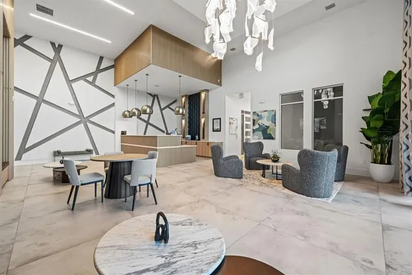 a living room with furniture a chandelier and a dining room