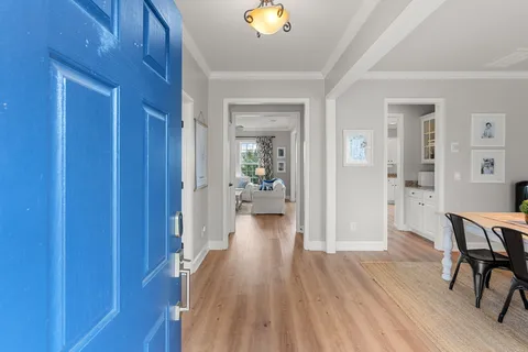 a view of a hallway view with wooden floor and furniture