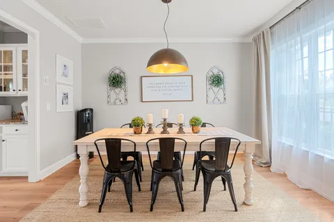 a view of a dining room with furniture and window