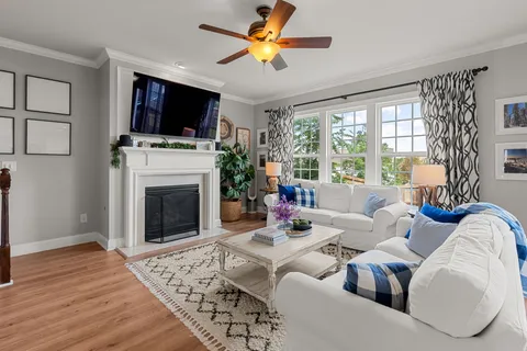 a living room with furniture a fireplace and a flat screen tv