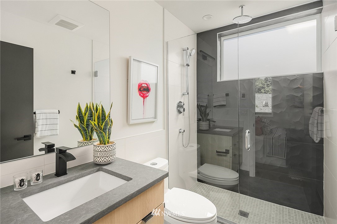 3664 Interlake Avenue North, Unit B Seattle, WA 98103 - Photo 11 of 13 a bathroom with a sink a toilet and shower