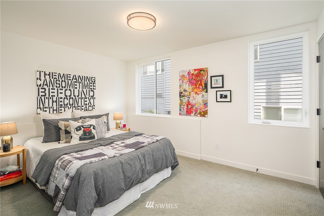 3664 Interlake Avenue North, Unit B Seattle, WA 98103 - Photo 4 of 13 a bedroom with a bed and a window