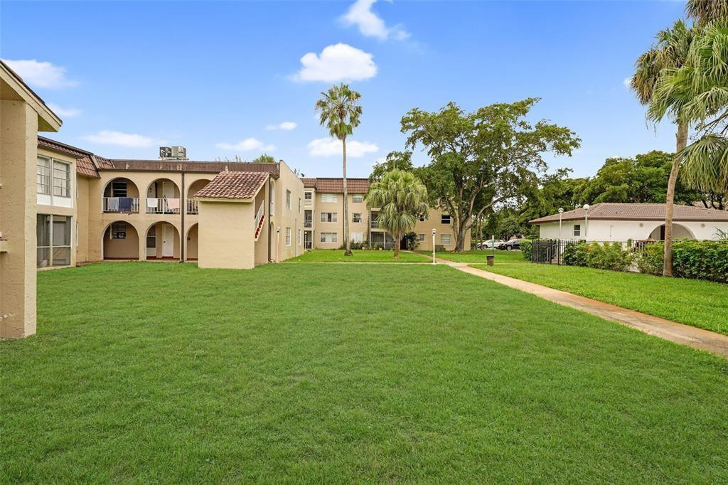 2710 Riverside Drive, Unit 106A Coral Springs, FL 33065 - Photo 1 of 8 a view of a house with a big yard