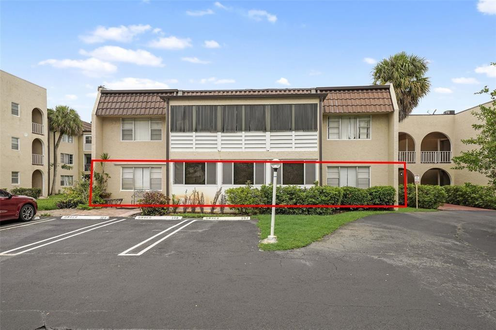 2710 Riverside Drive, Unit 106A Coral Springs, FL 33065 - Photo 3 of 8 a front view of a house with a yard