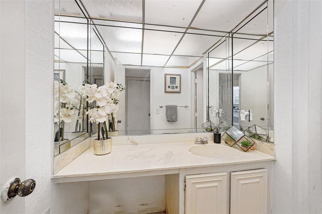 2710 Riverside Drive, Unit 106A Coral Springs, FL 33065 - Photo 7 of 8 a bathroom with a sink and a mirror
