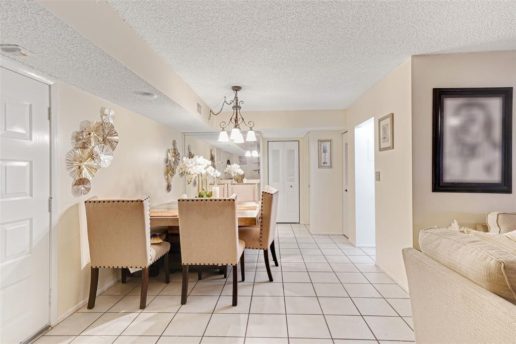 2710 Riverside Drive, Unit 106A Coral Springs, FL 33065 - Photo 8 of 8 a view of a dining room with furniture and chandelier