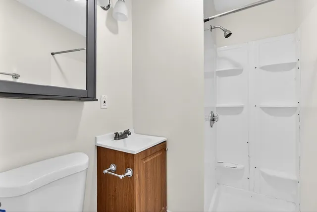 a bathroom with a sink toilet and shower