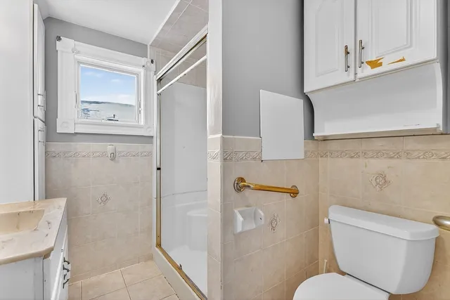 a bathroom with a toilet and a shower