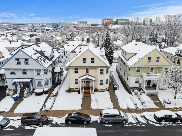 a view of residential houses with car parked
