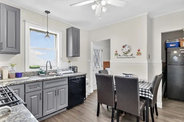 a kitchen with a table chairs refrigerator and cabinets