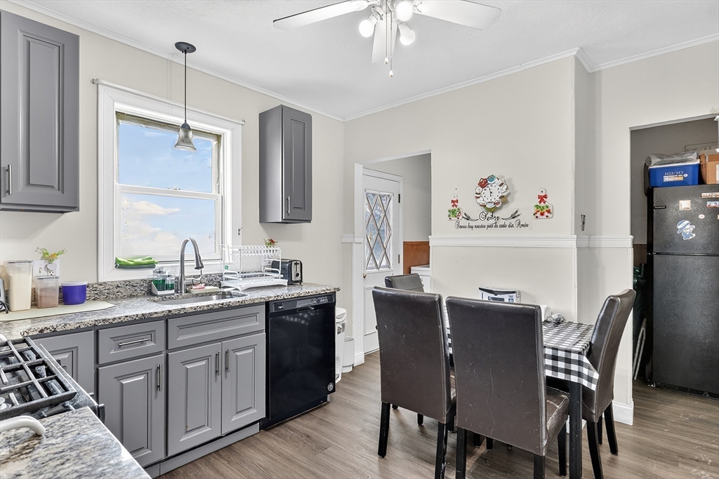 36-38 Mapleton Street Boston, MA 02135 - Photo 25 of 41 a kitchen with a table chairs refrigerator and cabinets