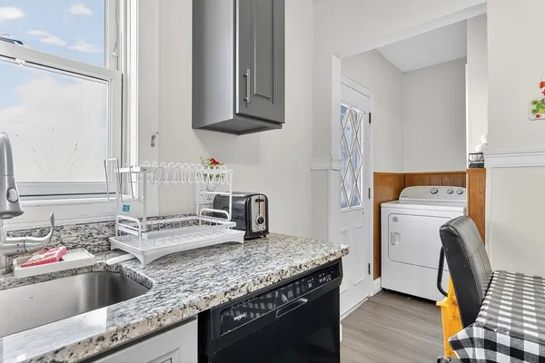 a kitchen that has a sink and a stove in it