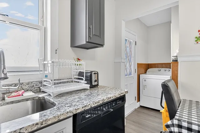 a kitchen that has a sink and a stove in it