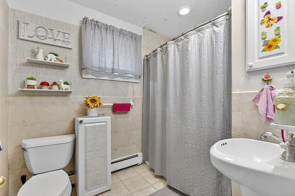 a bathroom with a sink toilet and window