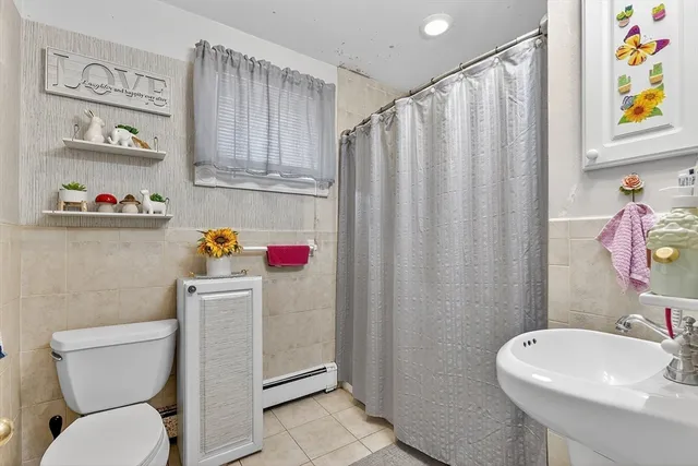 a bathroom with a sink toilet and window