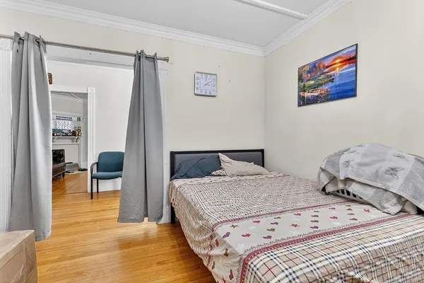 a bedroom with a bed and a chair