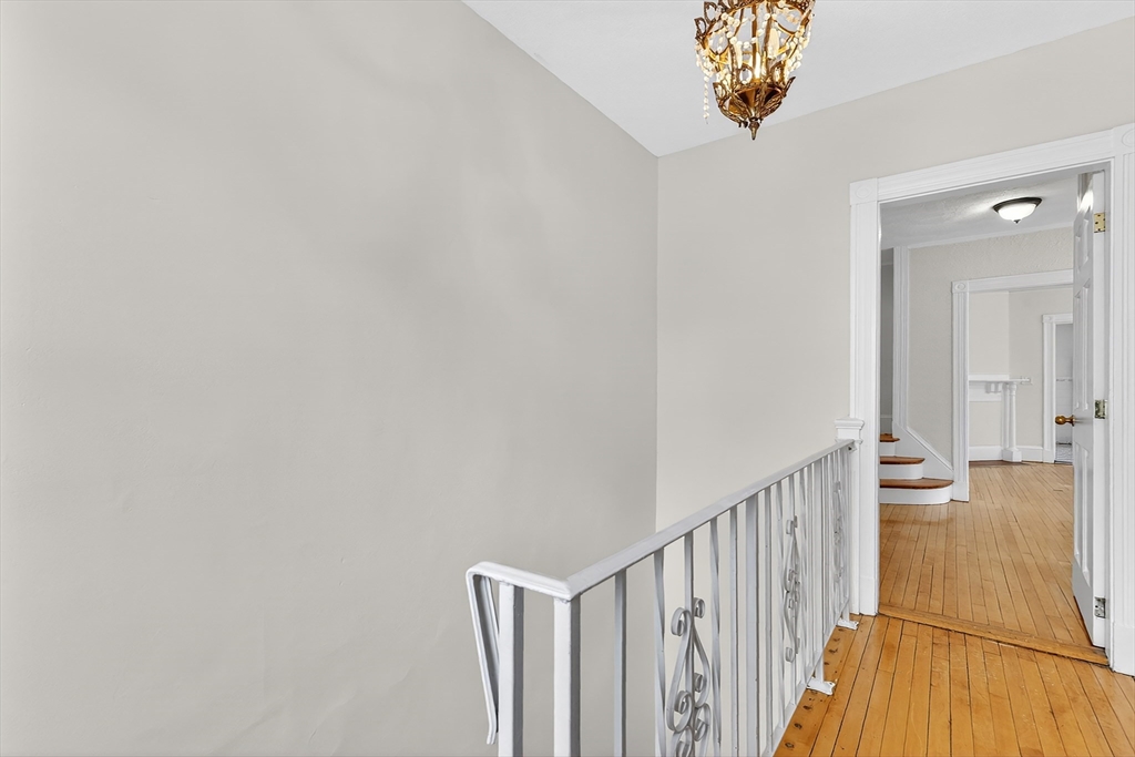 36-38 Mapleton Street Boston, MA 02135 - Photo 4 of 41 a view of a hallway with a chandelier
