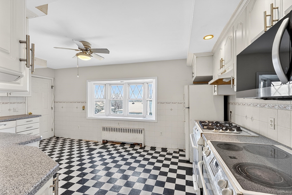 36-38 Mapleton Street Boston, MA 02135 - Photo 6 of 41 a kitchen with a sink stove and cabinets