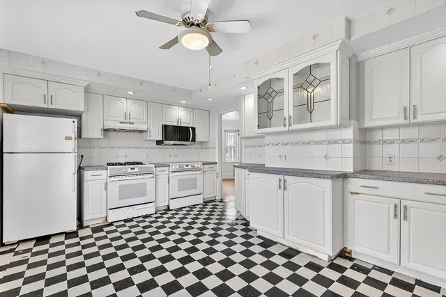 a kitchen with stainless steel appliances a refrigerator sink and cabinets