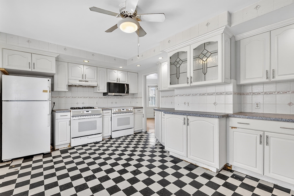 36-38 Mapleton Street Boston, MA 02135 - Photo 7 of 41 a kitchen with stainless steel appliances a refrigerator sink and cabinets