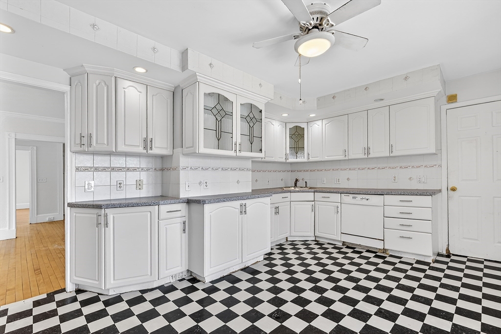 36-38 Mapleton Street Boston, MA 02135 - Photo 8 of 41 a kitchen with stainless steel appliances granite countertop a sink and cabinets