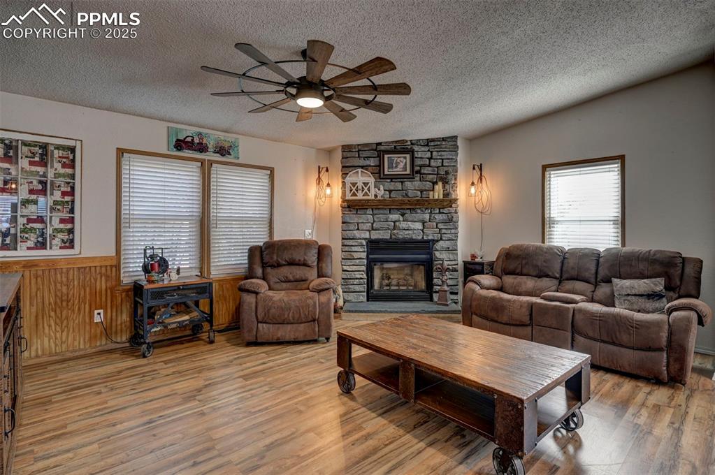 35355 Funk Road Calhan, CO 80808 - Photo 16 of 31 a living room with furniture a fireplace and a window