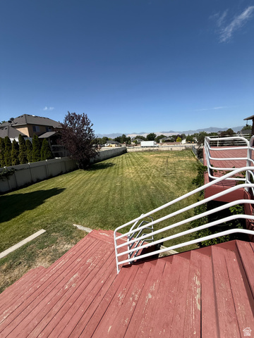 328 Heather Ridge Circle Sandy, UT 84070 - Photo 15 of 32 Expansive backyard with a manicured lawn, established landscaping, and perimeter fencing
