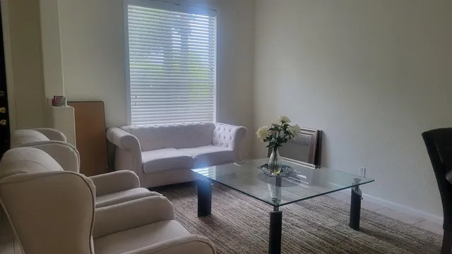 a living room with furniture and a window