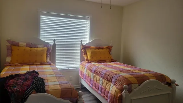 a bedroom with a bed and window