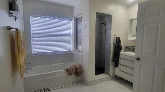 a bathroom with a bathtub and a shower
