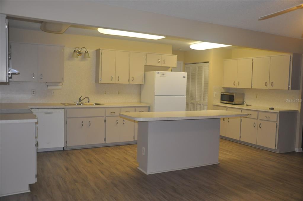 9157 Southwest 82nd Terrace, Unit C Ocala, FL 34481 - Photo 12 of 33 a kitchen with a sink window and cabinets