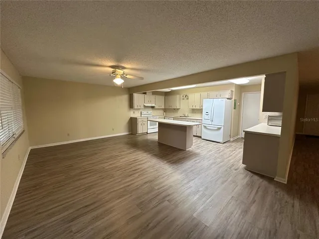 a view of a kitchen with wooden floor and a sink