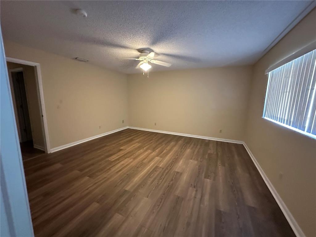 9157 Southwest 82nd Terrace, Unit C Ocala, FL 34481 - Photo 19 of 33 a view of room with window and ceiling fan