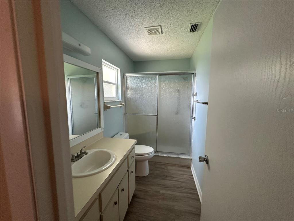 9157 Southwest 82nd Terrace, Unit C Ocala, FL 34481 - Photo 22 of 33 a bathroom with a sink a toilet and shower