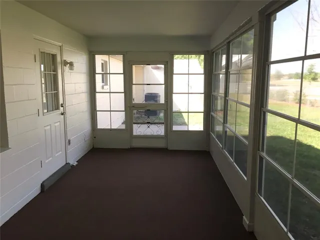 a view of hallway with stairs and wooden floor