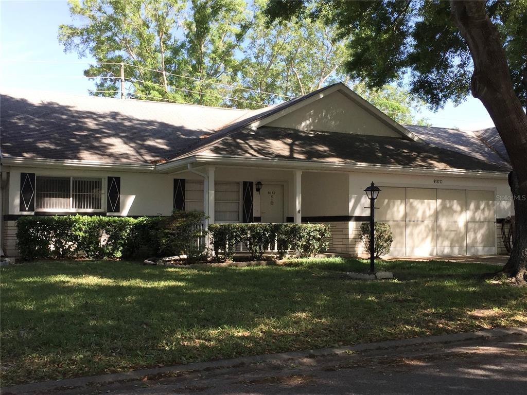 9157 Southwest 82nd Terrace, Unit C Ocala, FL 34481 - Photo 3 of 33 a front view of a house with a yard