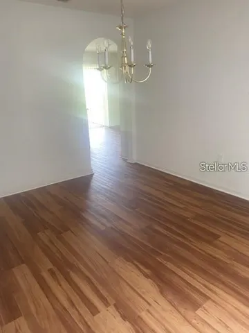 a view of a room with wooden floor and large windows