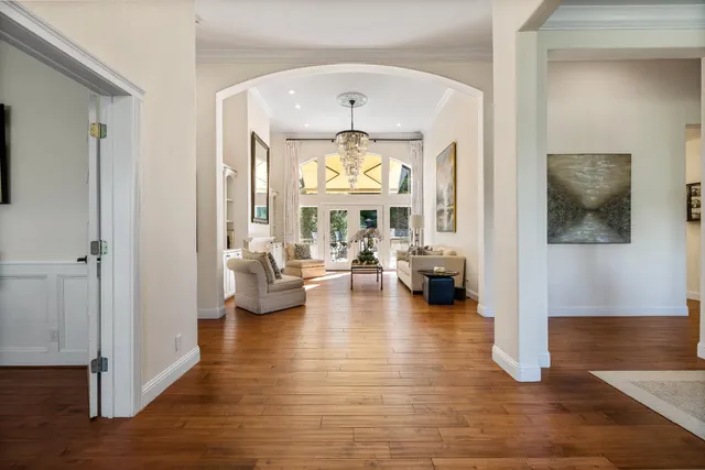 a view of a livingroom with wooden floor and furniture