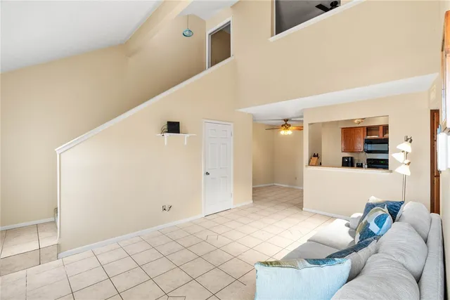 a living room with furniture and view of kitchen