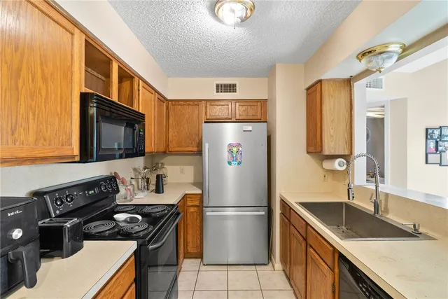 a kitchen with a stove a refrigerator and a sink