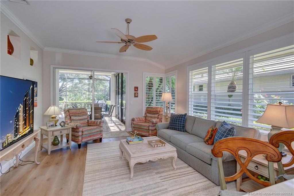 3531 Southeast Cambridge Drive Stuart, FL 34997 - Photo 13 of 44 a living room with furniture and a flat screen tv