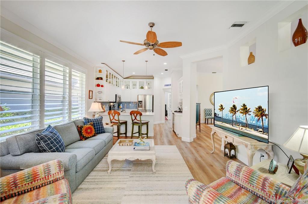 3531 Southeast Cambridge Drive Stuart, FL 34997 - Photo 14 of 44 a living room with furniture a couch and a window