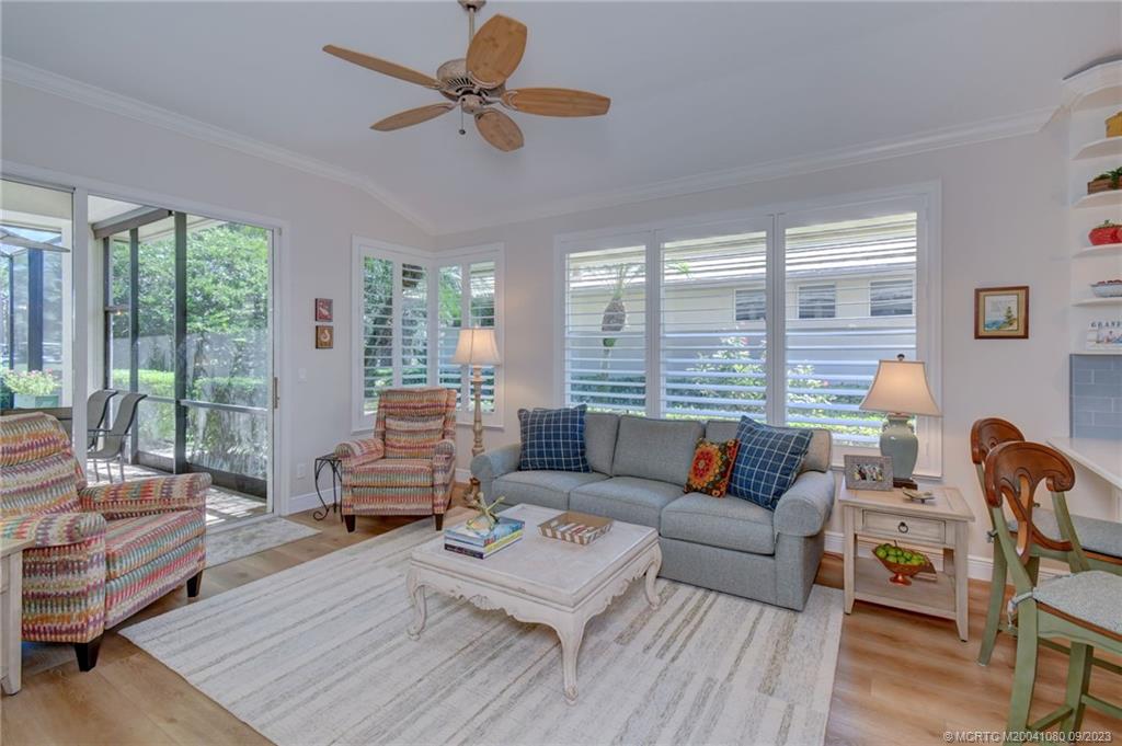 3531 Southeast Cambridge Drive Stuart, FL 34997 - Photo 15 of 44 a living room with furniture and a large window