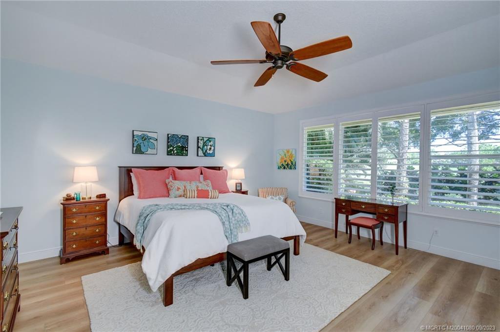 3531 Southeast Cambridge Drive Stuart, FL 34997 - Photo 23 of 44 a bedroom with a large bed and a large window