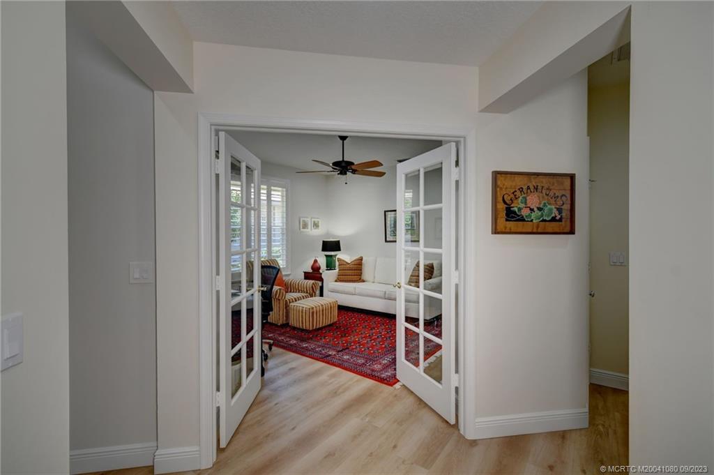 3531 Southeast Cambridge Drive Stuart, FL 34997 - Photo 28 of 44 a living room with furniture and a wooden floor
